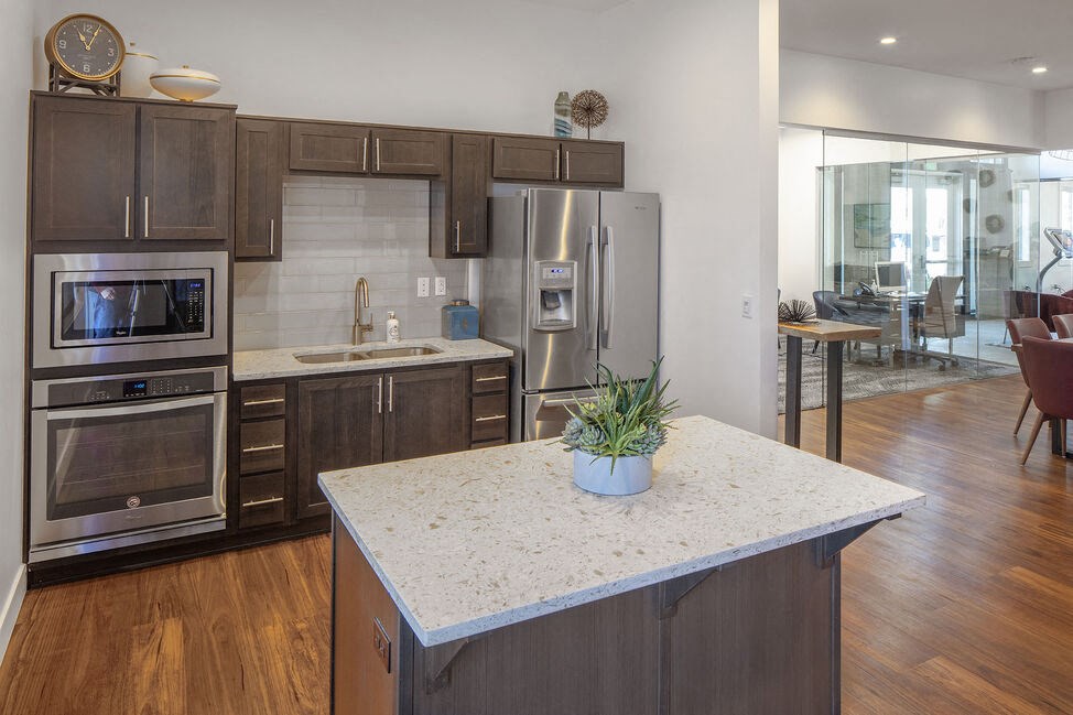 a kitchen with a large island with a potted plant on top of it