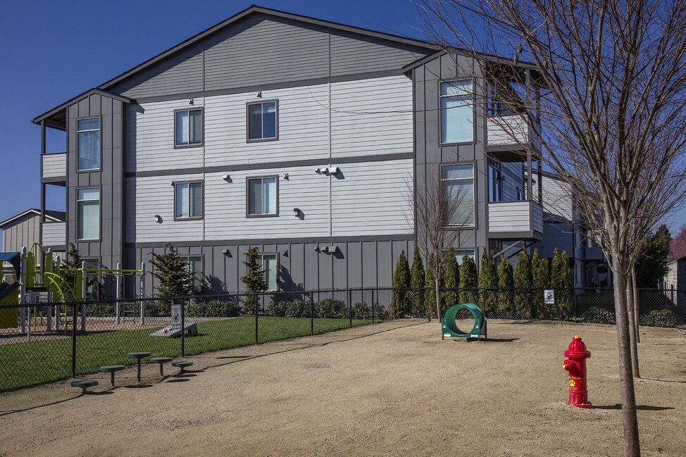 a red fire hydrant sitting in front of a building
