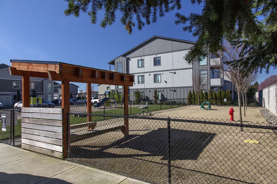 a dog park in front of an apartment building