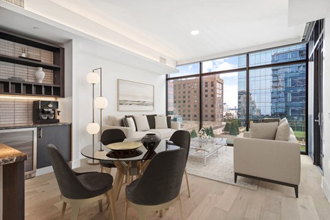 A modern living room with a glass table and chairs.
