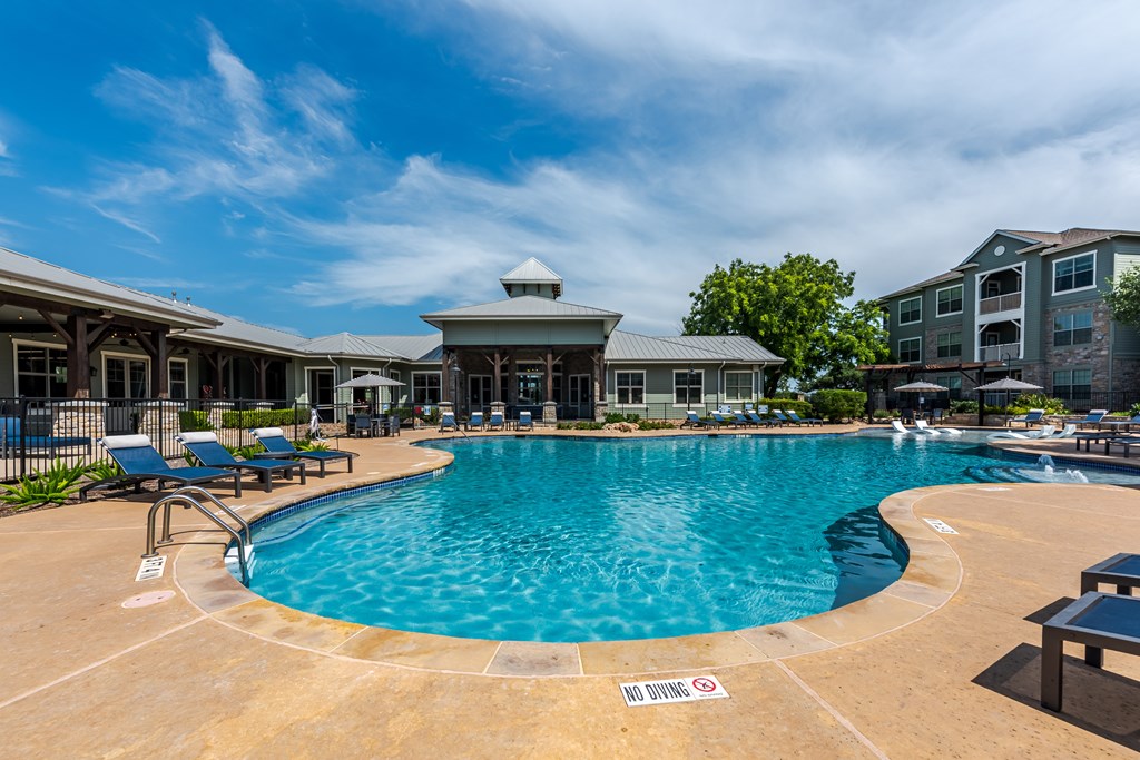 A pool with a sign that says "NO DIVING" on the ground.