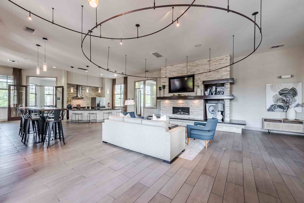 A modern living room with a fireplace and a TV mounted above it.