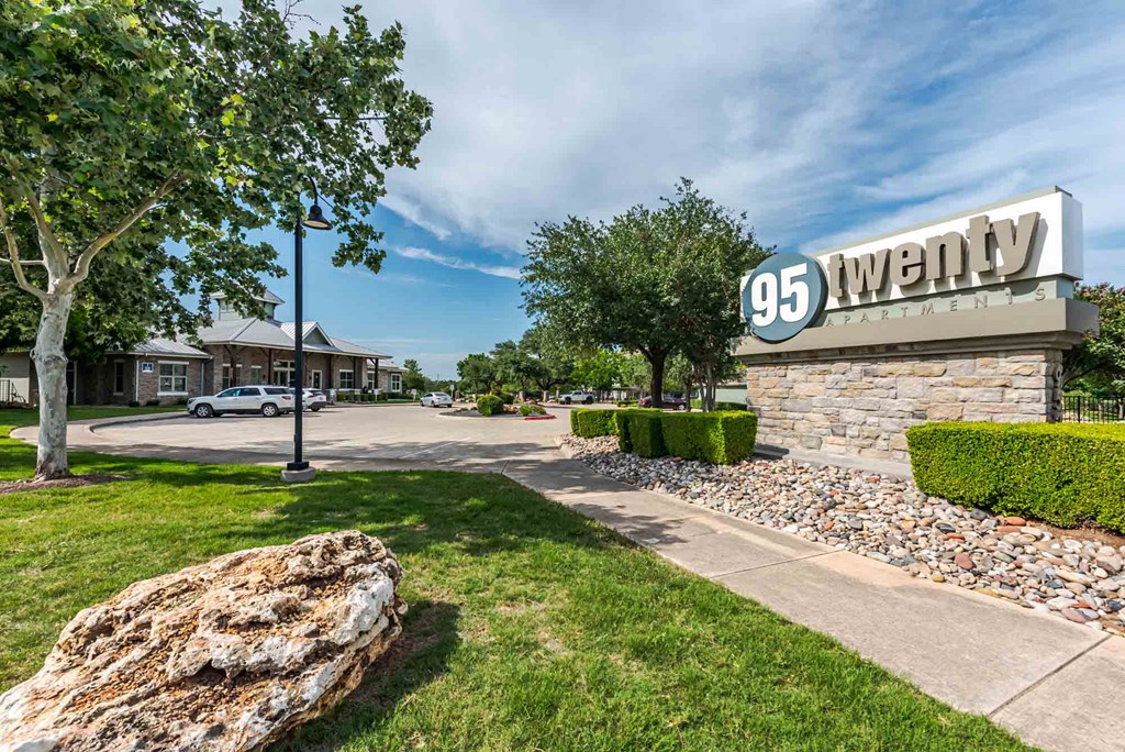 A sign that says 95 Twenty in front of a building.