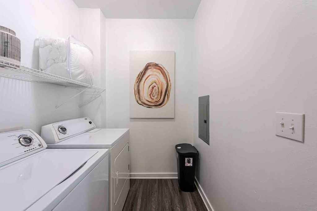 A small laundry room with a washer and dryer.