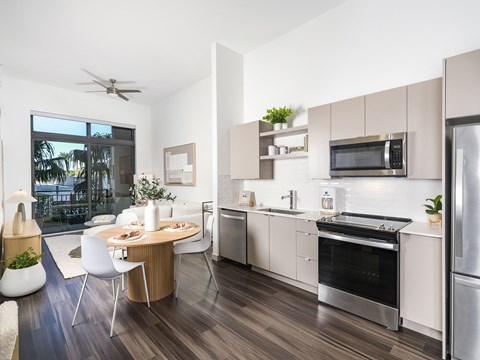 A modern kitchen with a dining table and chairs.