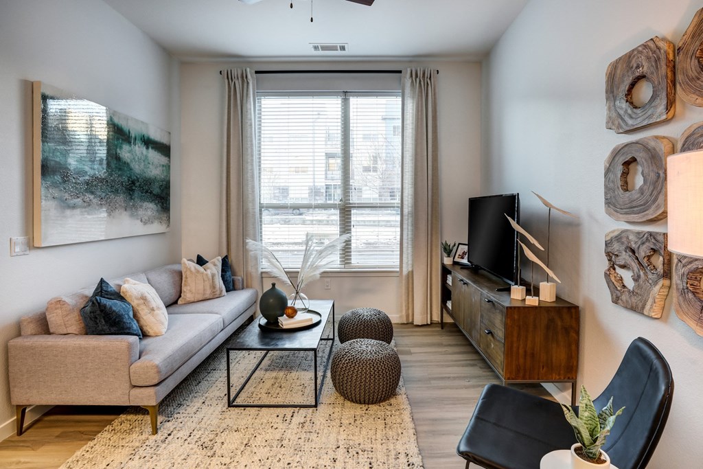 a living room with a couch a coffee table and a tv