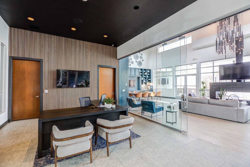 a lobby with a desk chairs and a couch