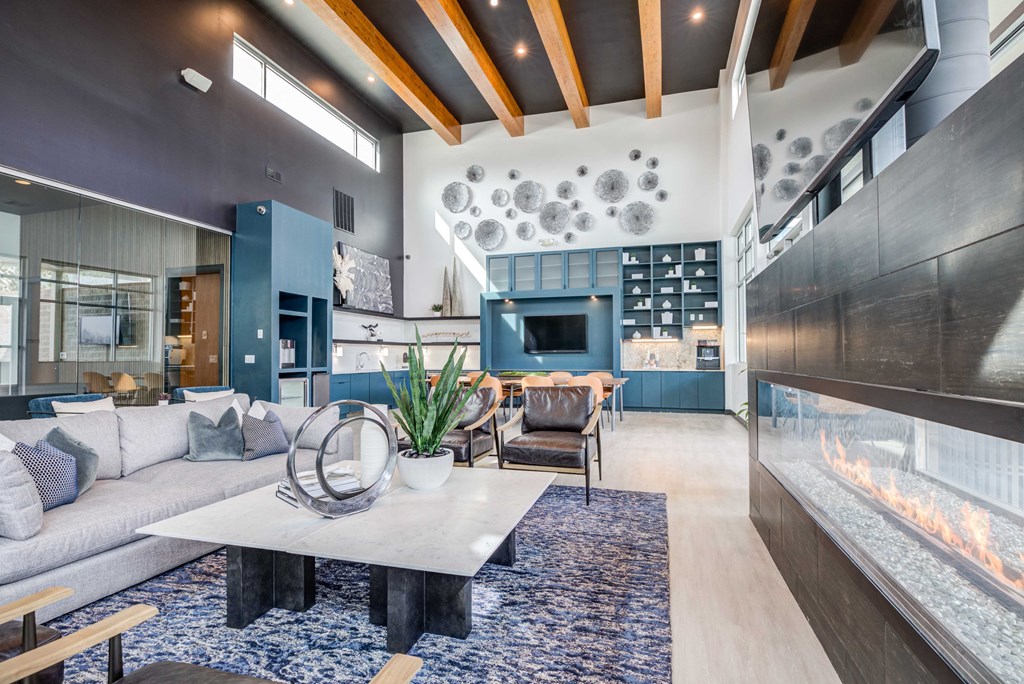 a living room filled with furniture and a large fireplace