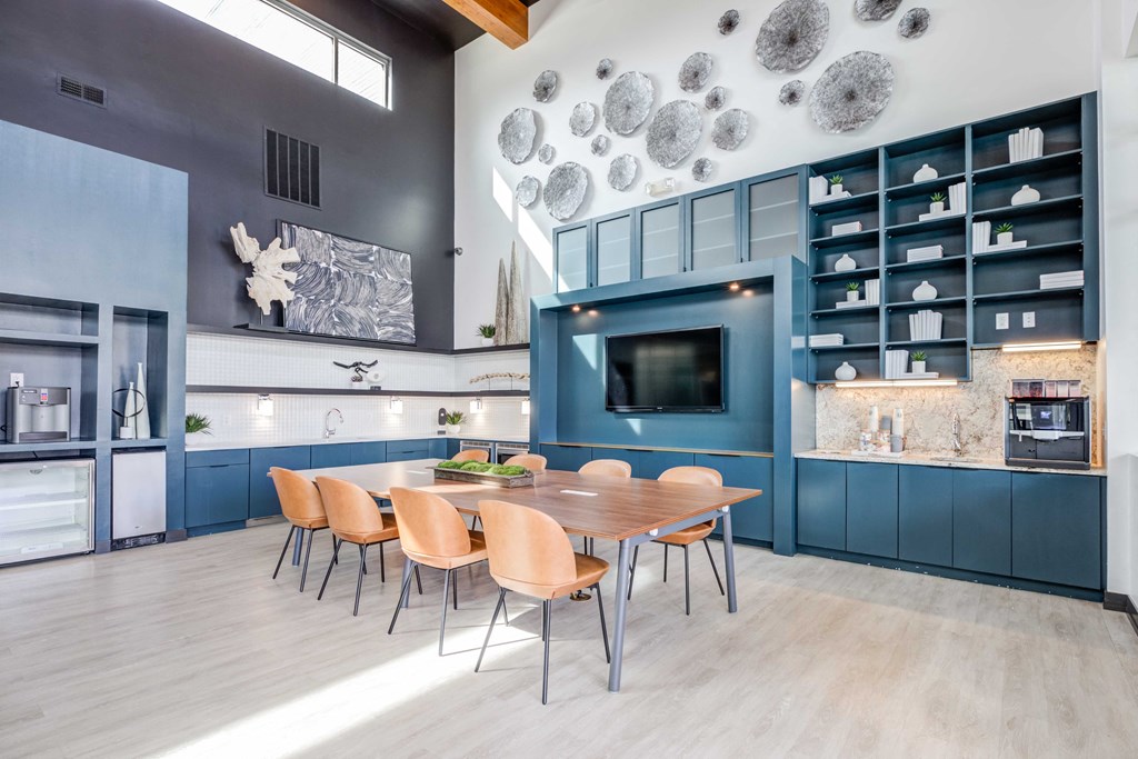 a kitchen with blue cabinets and a wooden table and chairs