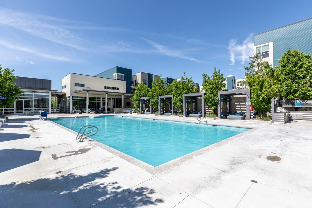 a swimming pool with a building in the background
