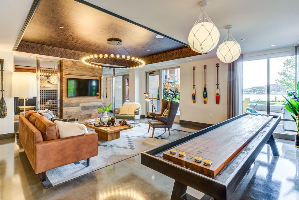 a living room with a pool table and a television