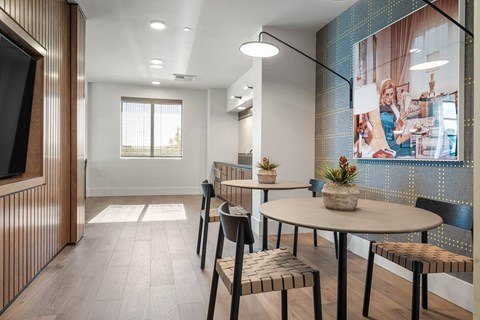 A modern dining area with a round table and chairs.