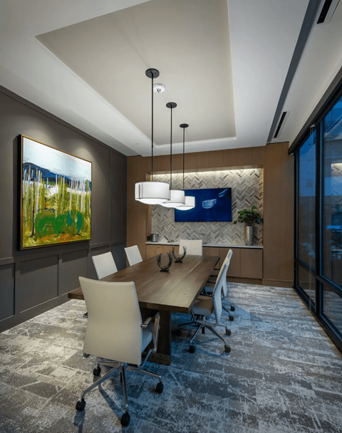 a conference room with a wooden table and chairs