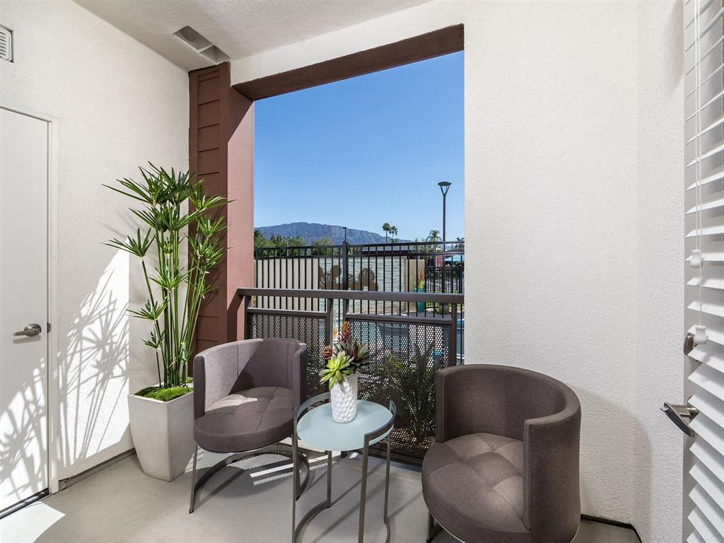 a patio with two chairs and a table