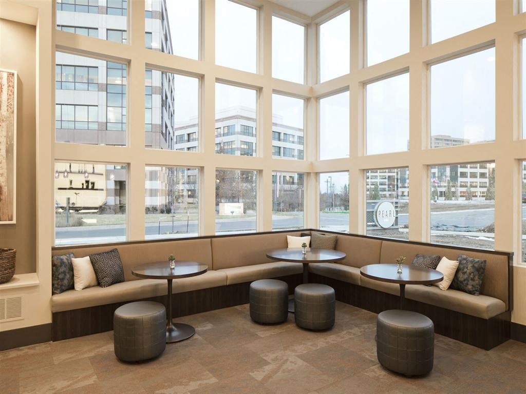 Large window with a row of tables and benches in front of it at Pearl DTC, Denver, Colorado