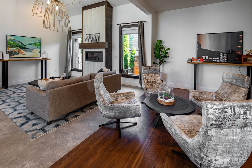 a living room with couches and chairs and a tv
