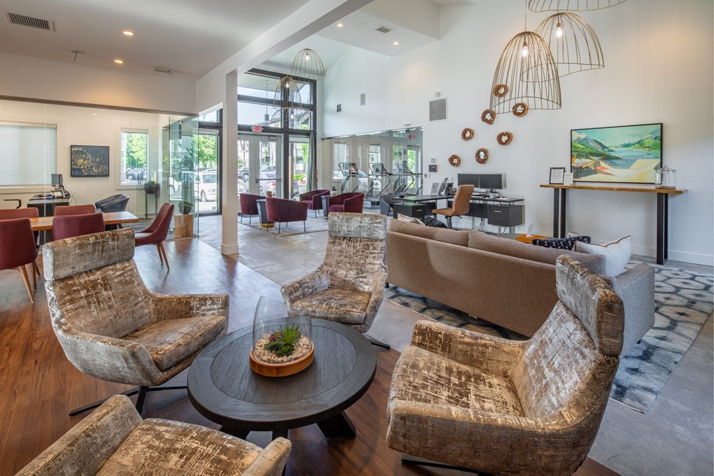 a living room with couches and chairs and a table