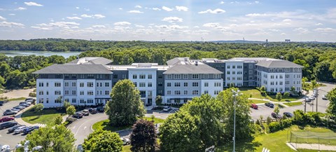 an aerial view of The Cove in Hingham, MA with the ocean in the background