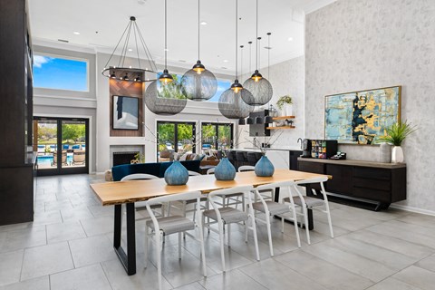 a dining room with a wooden table and chairs