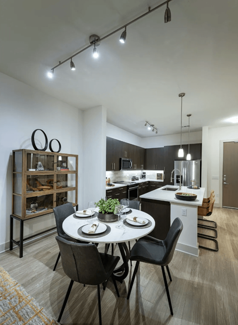 an open kitchen and dining room with a table and chairs