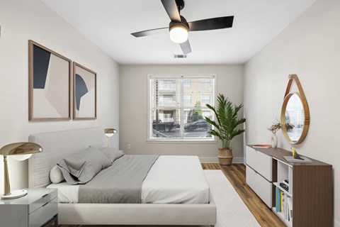 a bedroom with a large bed and a ceiling fan