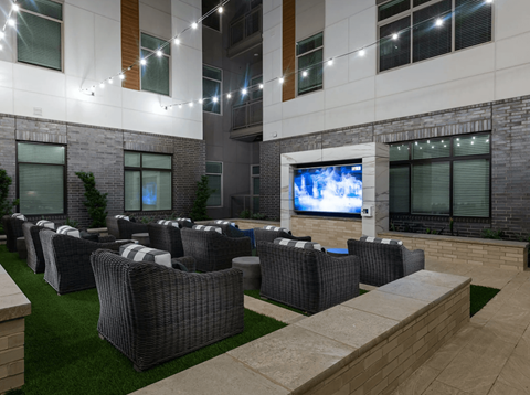 a lounge area with chairs and a television in an office building