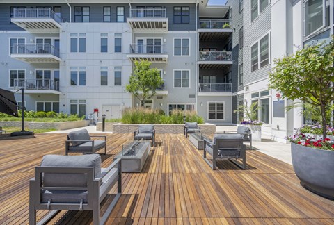 an outdoor lounge area at The Cove apartments in Hingham, MA