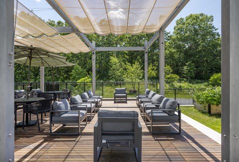 a patio with chairs and umbrellas