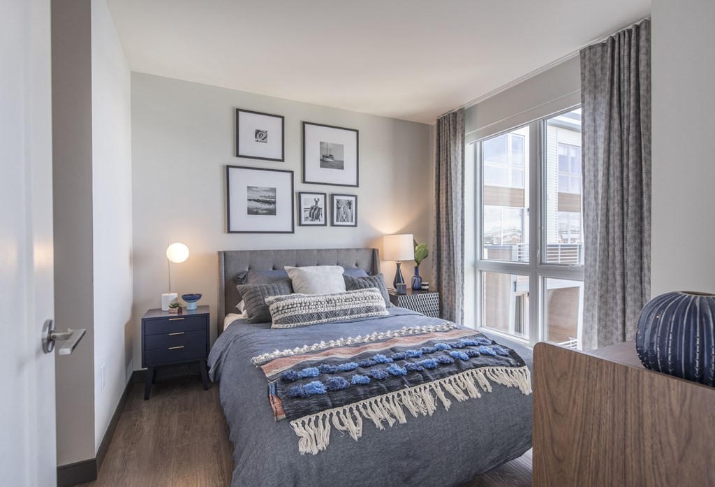 a bedroom with a large bed and a window