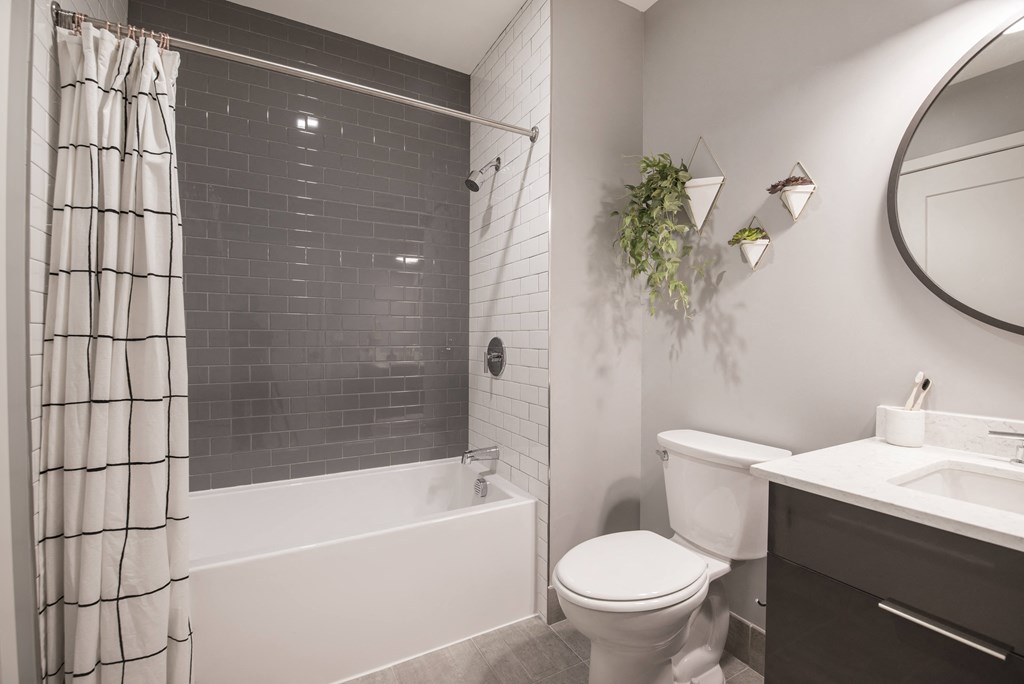 a bathroom with a toilet and a shower and a sink