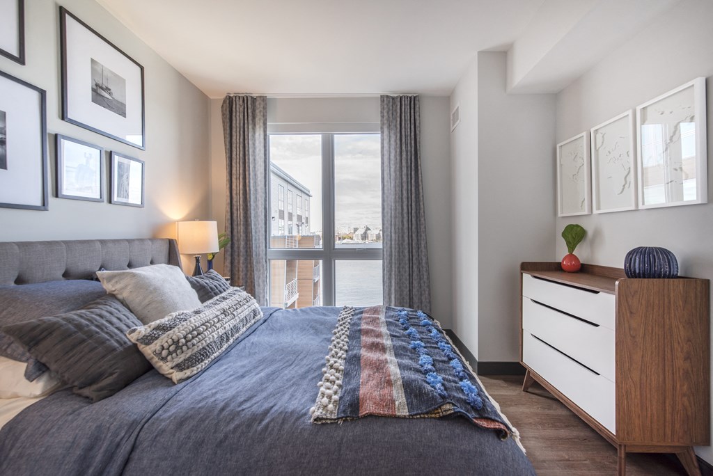 a bedroom with a large bed and a window