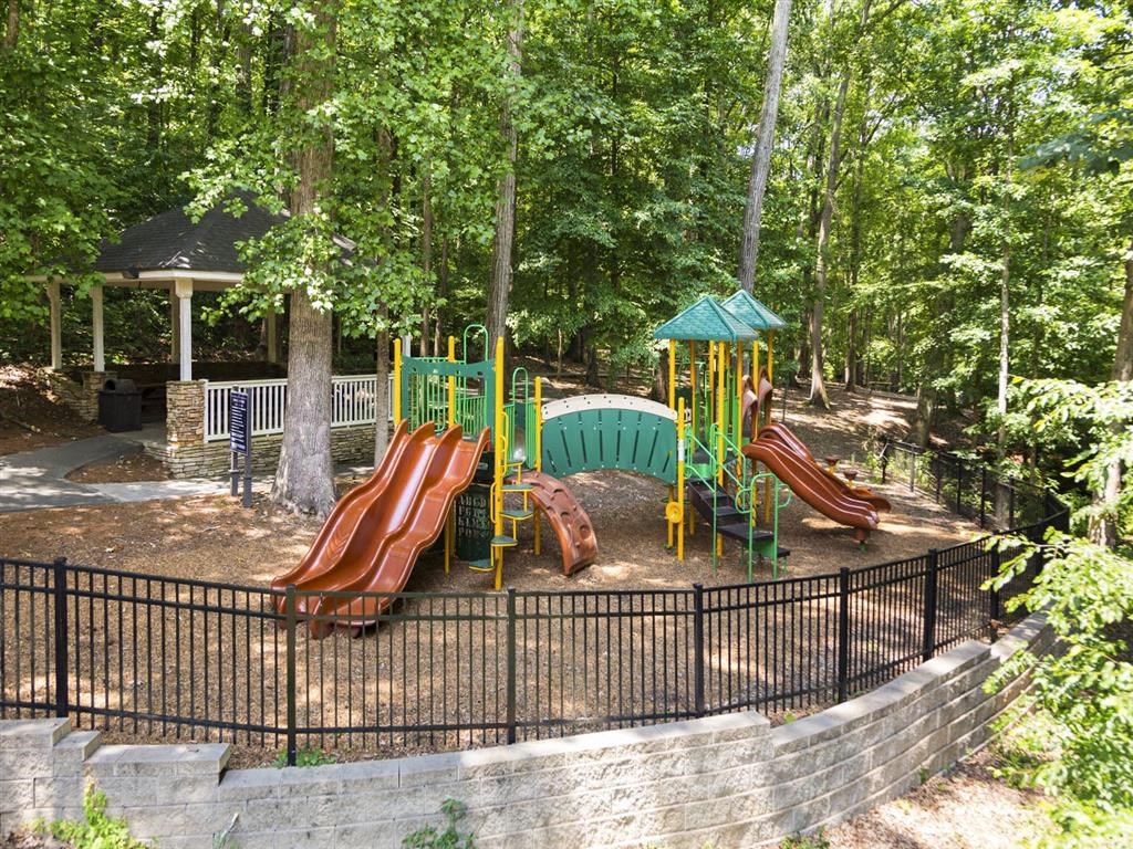 a playground with slides and a gazebo in a park