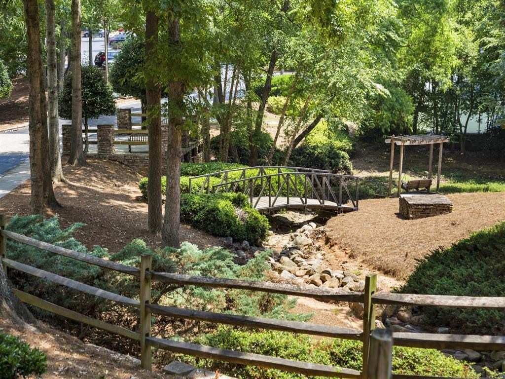 a bridge over a creek in a park