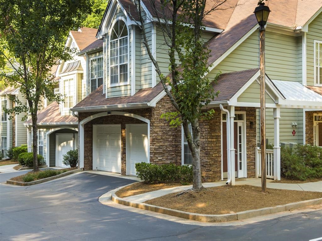 the front of a house with a driveway and a streetlight