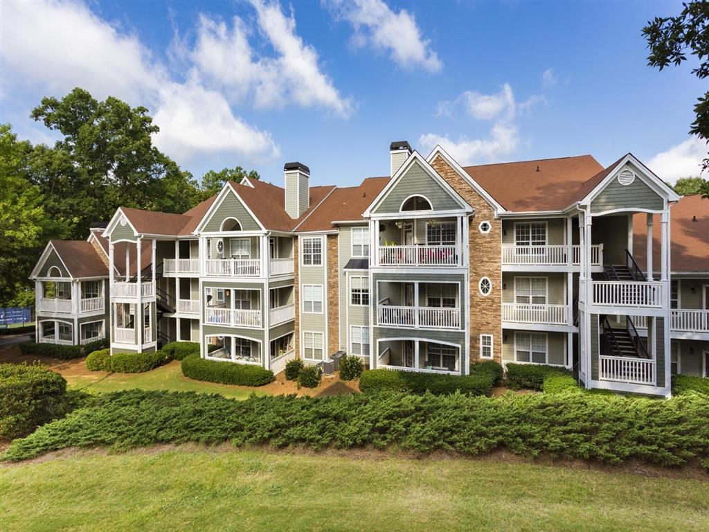 an aerial view of an apartment building with balconies and lawns