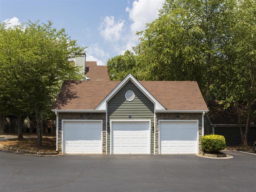 a garage with two garage doors in front of a house