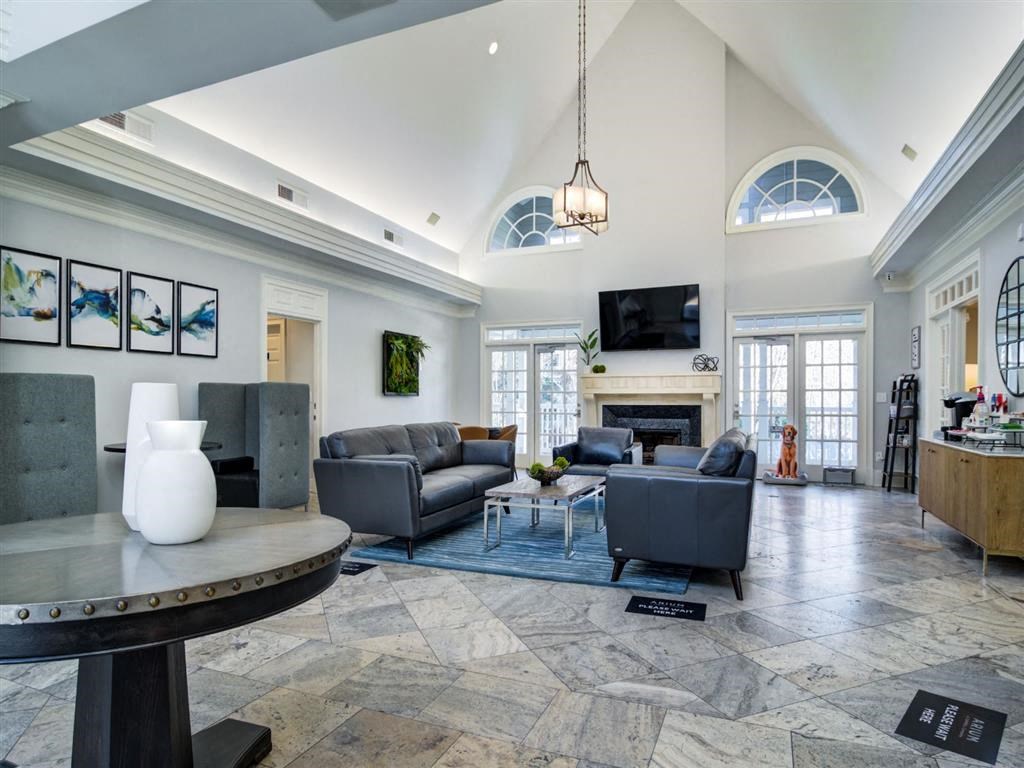 a large living room with couches and a fireplace