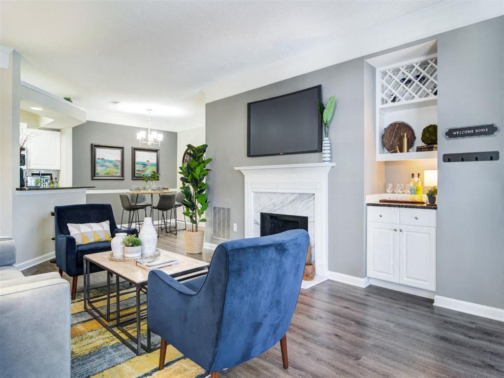 a living room with a fireplace and a tv