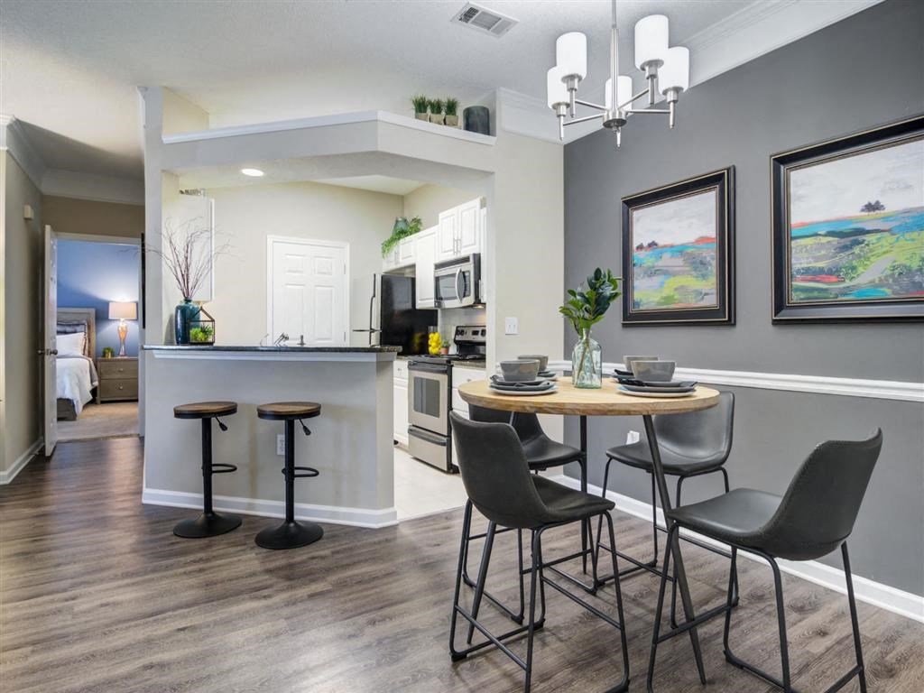 an open kitchen and dining area with a table and chairs