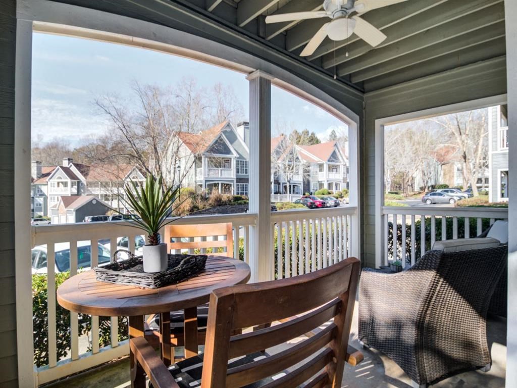 a screened in porch with a table and chairs