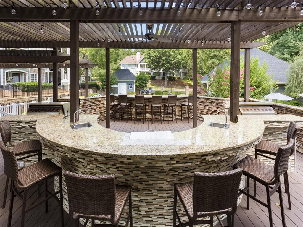 a patio with a table and chairs and a pergola