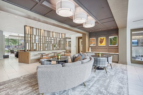 a lobby with couches and tables and a bar
