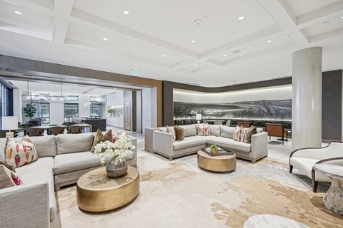 a living room with couches and tables and a balcony