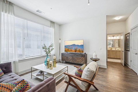 a view of a living room with a glass table and a couch