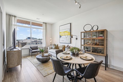 an open living room with a dining room table and a couch