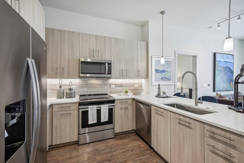 a kitchen with wooden cabinets and stainless steel appliances