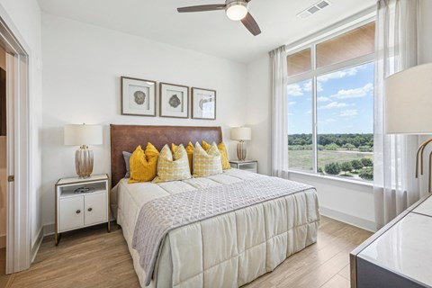 a bedroom with a bed and a large window