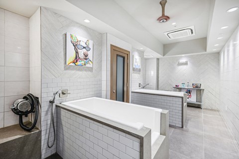 a large white bathroom with a tub and a shower