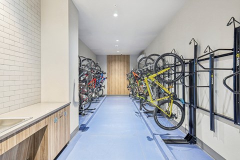 a rack of bikes in a room with a blue floor and white walls