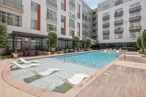 a swimming pool in front of an apartment building
